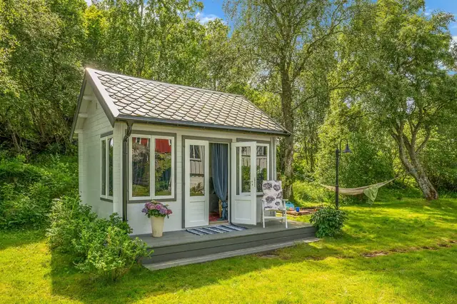 Koselig hagestue som har samme type skifertak som hovedhuset.